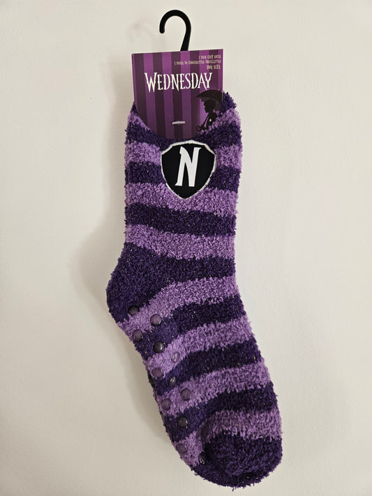 Wednesday Purple and black Nevermore Academy striped sock with a brand tag on a light gray background