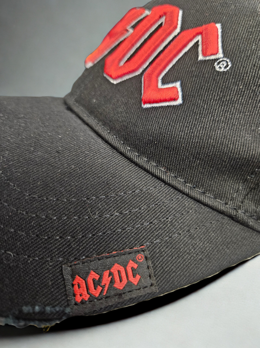 Gray cap with red 'AC/DC' logo on a gray background