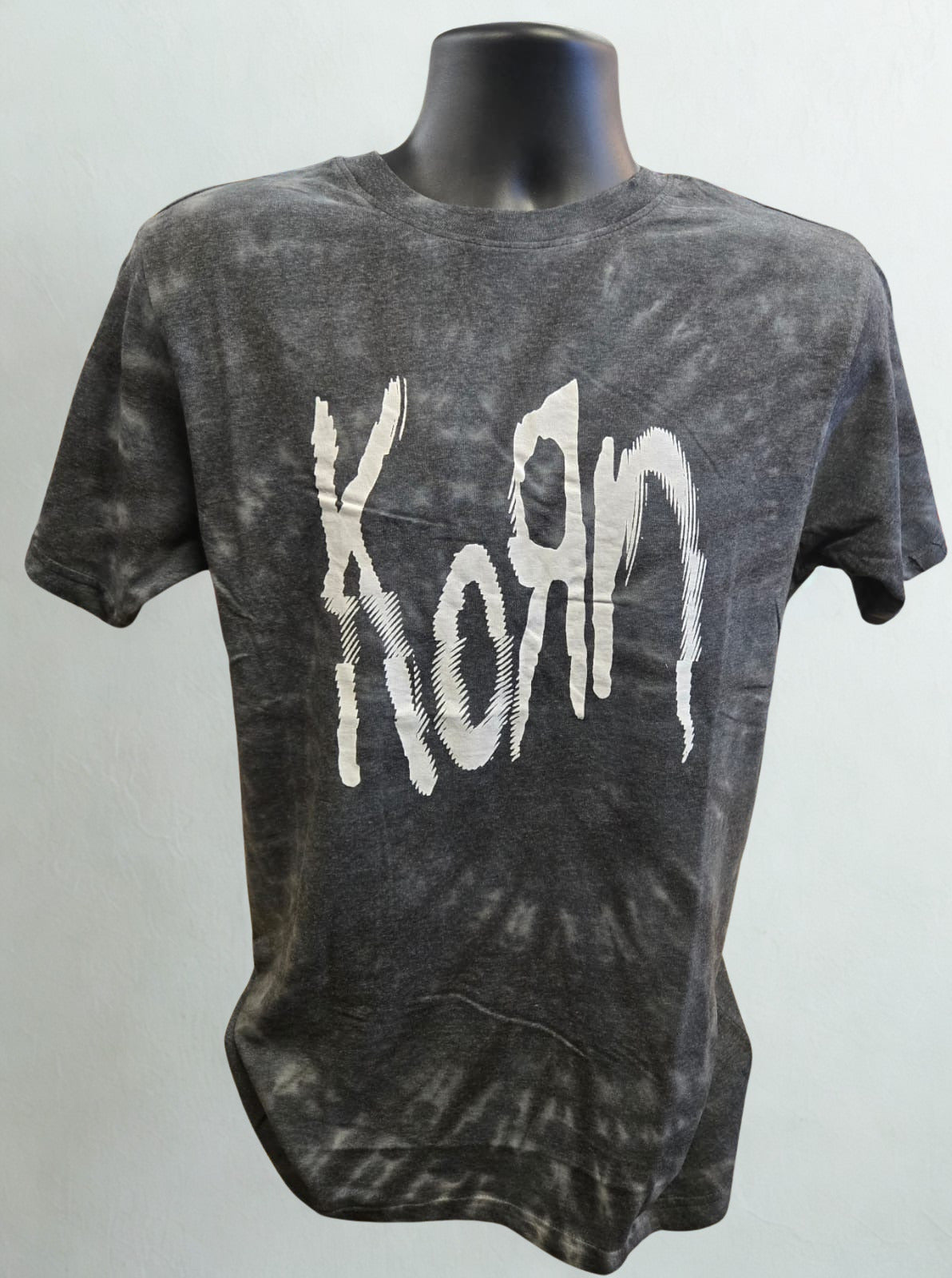 Gray tie-dye t-shirt with 'Korn' logo on a mannequin against a white background