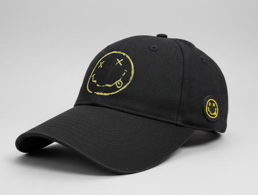 Black Nirvana cap with yellow smiley face design on a gray background