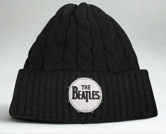 Black knit beanie with The Beatles logo on a white background